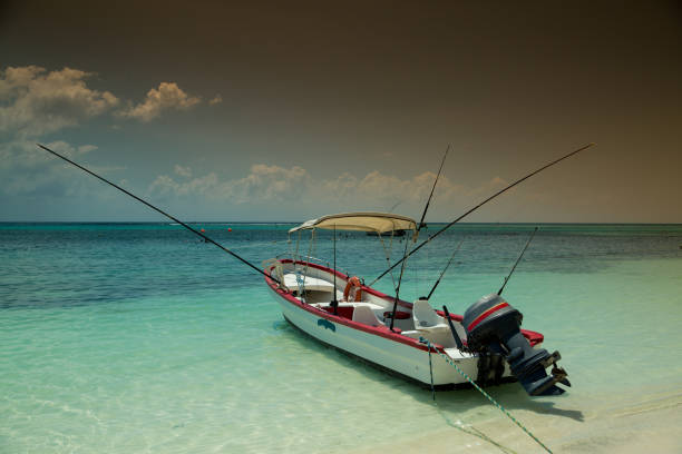 A long exposure photograph captures two small boats floating on a lightly wavy sea. The boats appear slightly blurred from gentle motion, blending with the softened surface of the water to create a calm and dreamlike atmosphere.