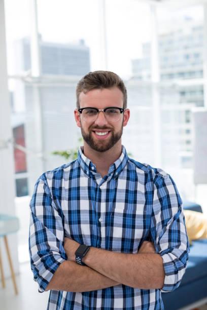 istock Male executive standing with arms crossed in office 848988462