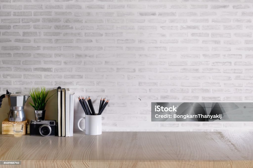 Mock up desk work space. Work space Mock up : wood desk tabletop with notebooks, vintage camera and houseplant. white marble desk with copy space for products display montage. Desk Stock Photo