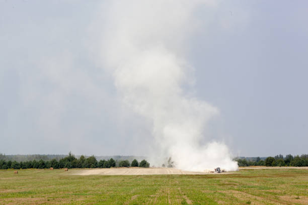 istock bright meadow and a tractor fertilizing the field 849004506