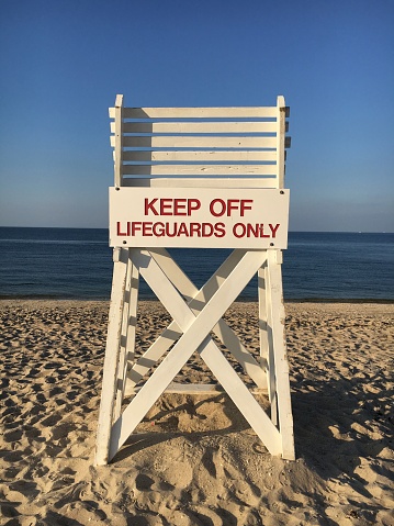A lifeguard chair on the beach facing towards Long Island Sound at Sunken Meadow State Park on the north shore of Long Island, New York.