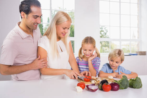 istock Family cutting vegetables together 849027984