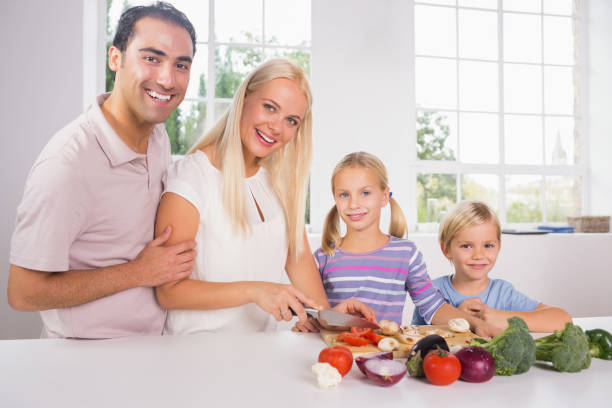 istock Smiling family cutting vegetables together 849027994