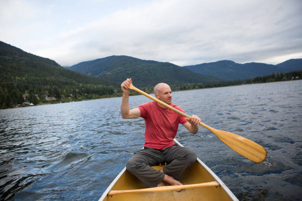 istock Fit male canoeing on a lake 849028694