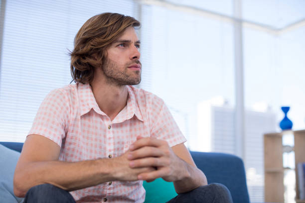 istock Depressed male executive sitting on sofa 849028726