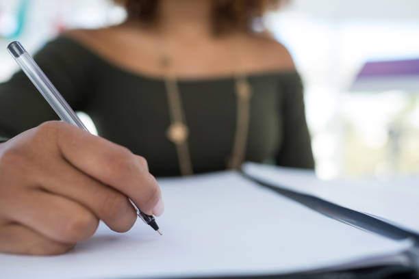 istock Female executive writing on a document at desk in the office 849030858