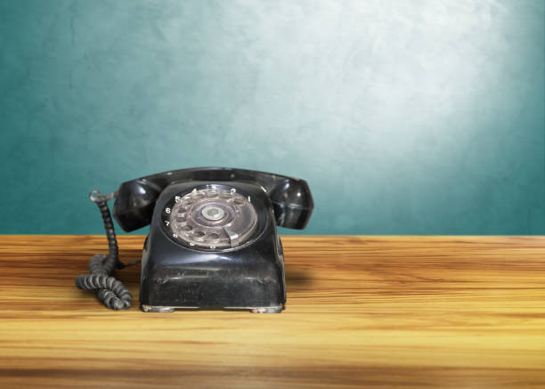 istock old classic vintage dial telephone on wooden table, communication 849037774