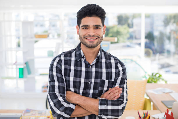 istock Male executive standing with arms crossed in the office 849042186