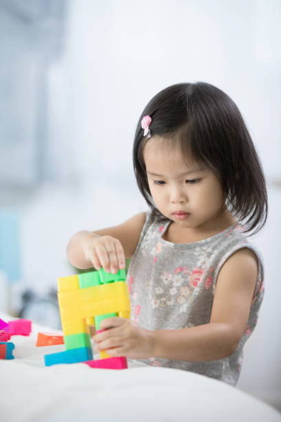 istock Asian cute child playing in the constructor block, 849053696