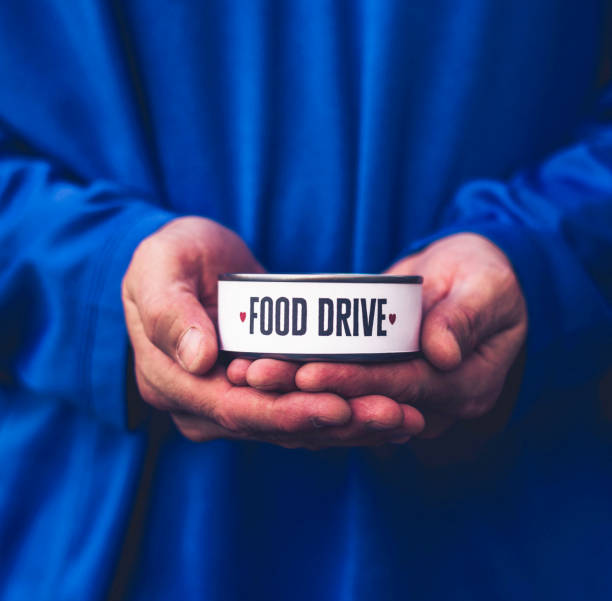 istock Male hands holding can promoting food drive 849069832