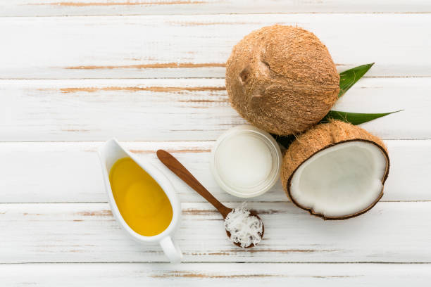 istock Coconut with coconut oil on white wooden table background. Good for package design element 849070668