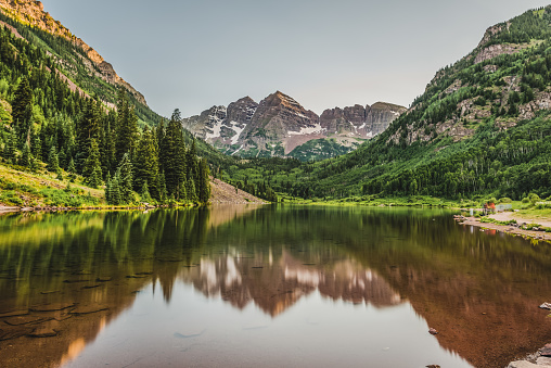 The Maroon Bells sit quite as the mid summer sun sets on the Aspen, Colorado landmark.