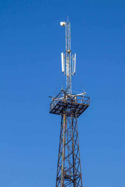 istock Metal tower with antennas for mobile cell phone communications against blue sky 849074890