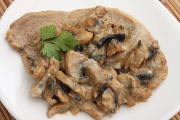 Veal escalope cooked in cream Veal escalope cooked in cream Mushrooms of Paris French cooking chervil stock pictures, royalty-free photos & images