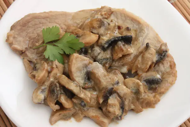 Veal escalope cooked in cream Mushrooms of Paris French cooking