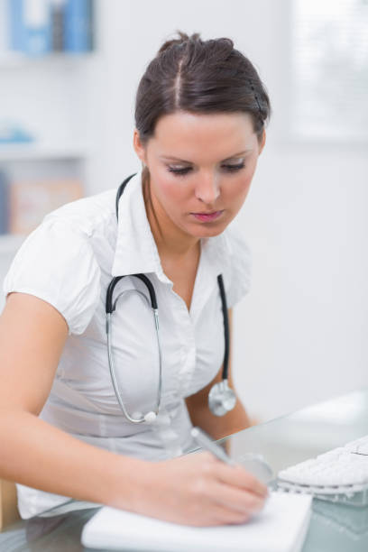 istock Doctor writing a prescription at desk 849078500