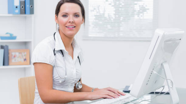 istock Female doctor using computer at clinic desk 849078512