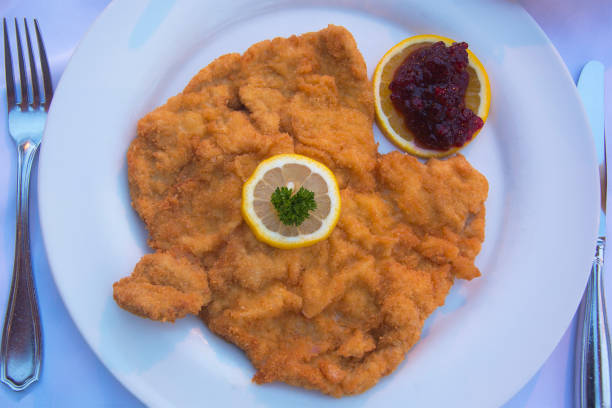 Authentic Schnitzel Wiener Art or Wiener Schnitzel vom Schwein (Pork) Served at as Restaurant in Innsbruck, Austria