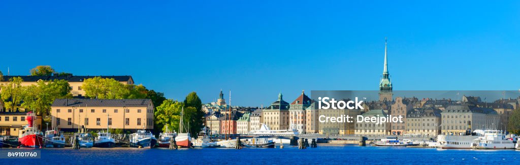 Gamla Stan City Skyline in Stockholm, Sweden Clear Blue Skies Over the City Skyline with Moored Boats and Pleasure Craft on the Lake Blue Stock Photo