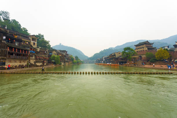 Fenghuang River Center Stepping Stone Bridge A stepping stone bridge spans the Tuojiang River which cuts through the center of the beautiful traditional village and tourist destination of Fenghuang fenghuang county photos stock pictures, royalty-free photos & images