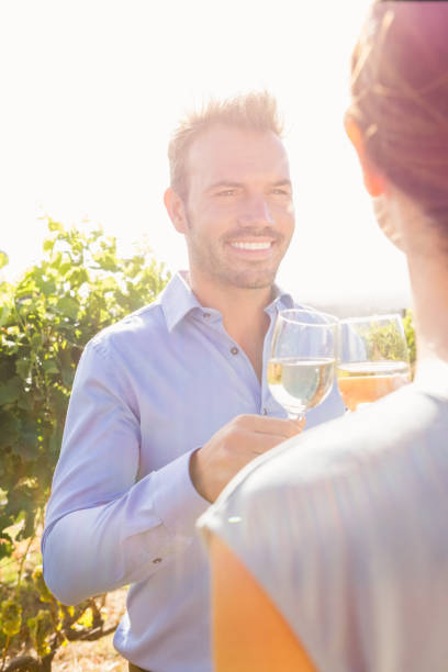 istock Smiling man with woman toasting wine 849110944