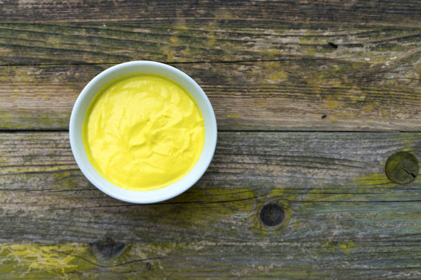 istock Mayonnaise sauce in a bowl on wooden background. 849117622