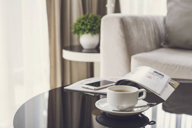 istock Cup of coffee on a round table with sofa in living room 849125062