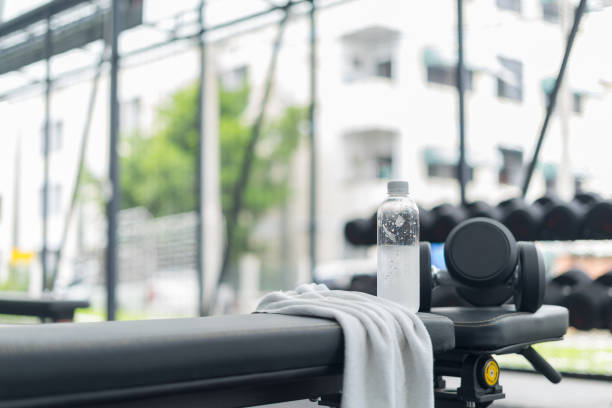 istock Fitness background with bottled water in gym 849128286
