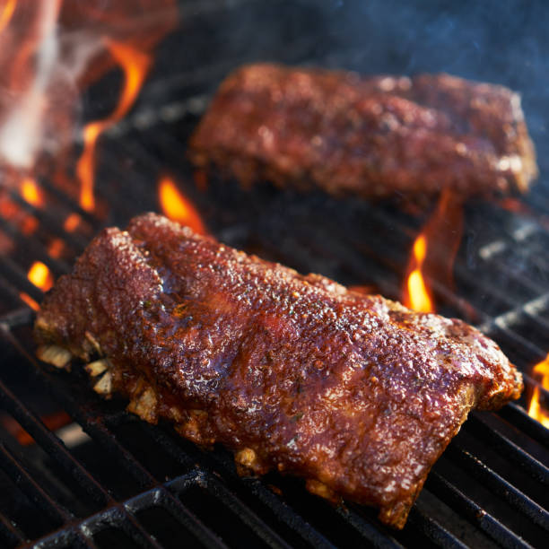 istock bbq pork ribs cooking on flaming grill 849128542