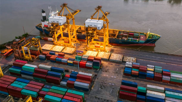 istock Logistics and transportation of Container Cargo ship and Cargo plane with working crane bridge in shipyard at sunrise, logistic import export and transport industry background 849133286