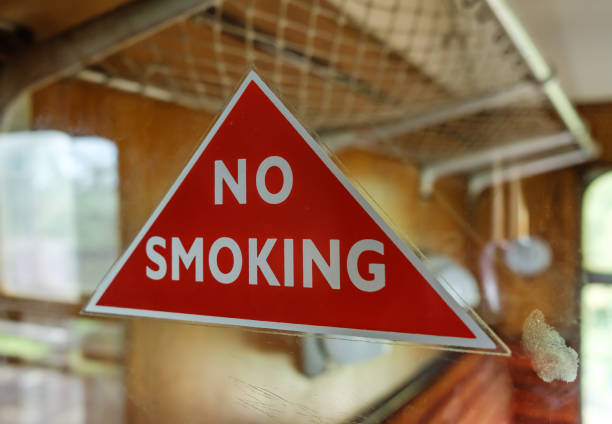istock Classical No Smoking warning triangle seen attached to a glass panel at a vintage, first class train compartment. 849137506