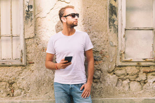 istock Modern guy using cellphone in the European city. 849137678