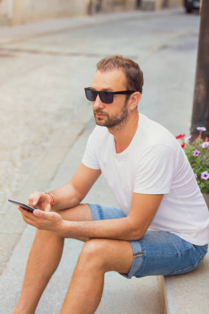 istock Modern guy using cellphone in the European city. 849140082