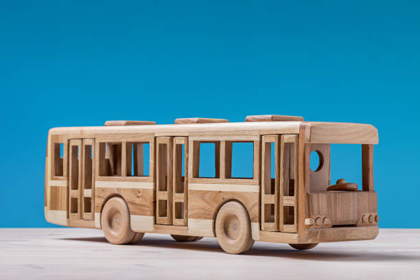 Toy, wooden bus on blue.