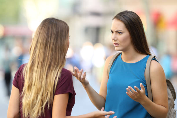 istock Two friends talking seriously on the street 849151680