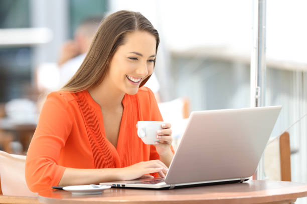 istock Happy woman browsing a laptop on line in a bar 849152588