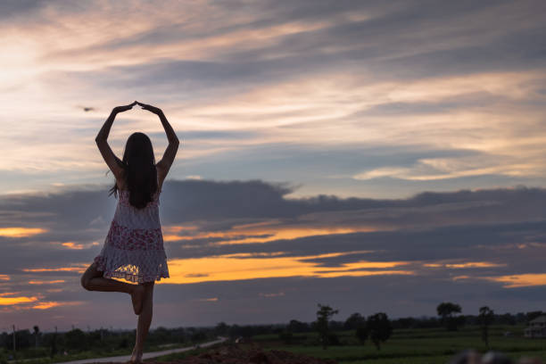 istock Beautiful asian woman standing on the mound with sunset 849158122
