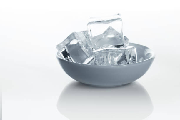 istock Bowl with ice cubes on white background 849159350