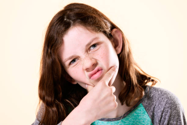 istock Tween girl frowns, making up her mind 849161980