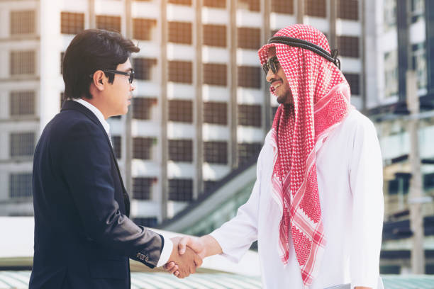 istock Arab man and businessman handshake 849162034