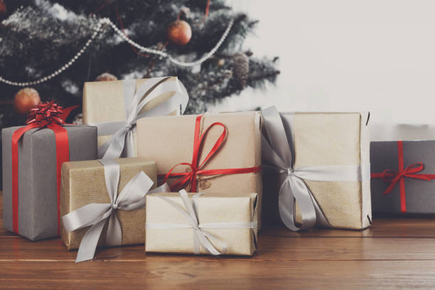 istock Christmas presents on decorated tree background, holiday concept 849162306
