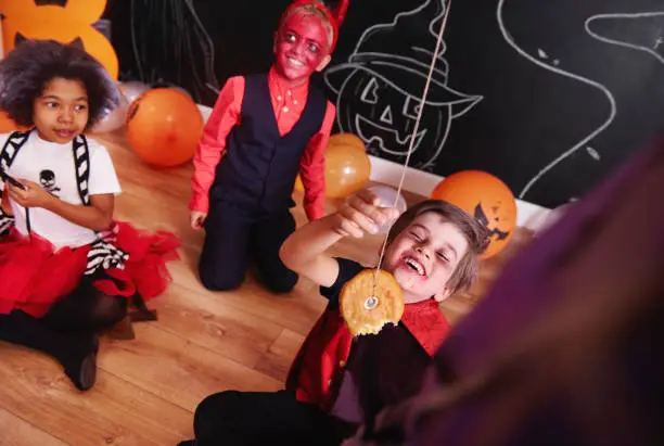 Photo of Boy trying to eat doughnuts