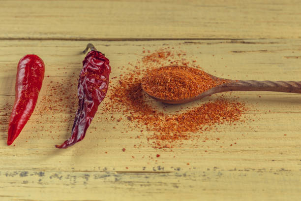 istock Red pepper fresh, dry and ground, on a wooden background, a look with a side 849166728