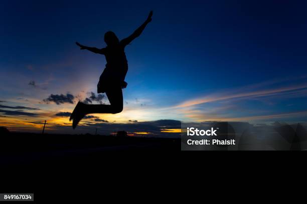 Silhouette Of Woman Posing At Sunset Or Sunrise Stock Photo - Download Image Now - Active Lifestyle, Adult, Adults Only