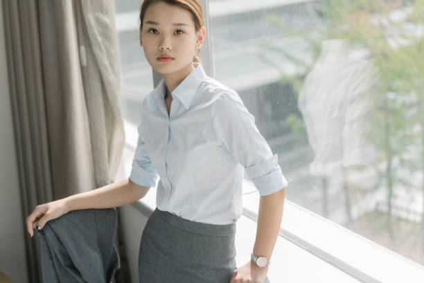 istock young confident business woman leaning on window sill 849172012