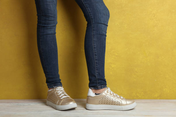 istock Sneakers on women's legs 849173626