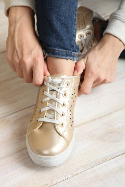 istock Sneakers on women's legs 849173644