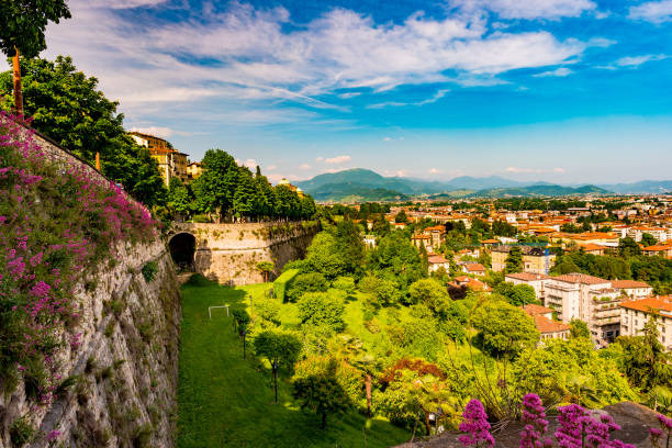 Panoramic view of Citta Alta, old town. Bergamo Panoramic view from Citta Alta, old town with the wall of old castle covered with flowers. Bergamo, Lombardy, Italy bergamo stock pictures, royalty-free photos & images