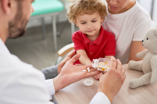 istock Giving Pills to Little Patient 849176476