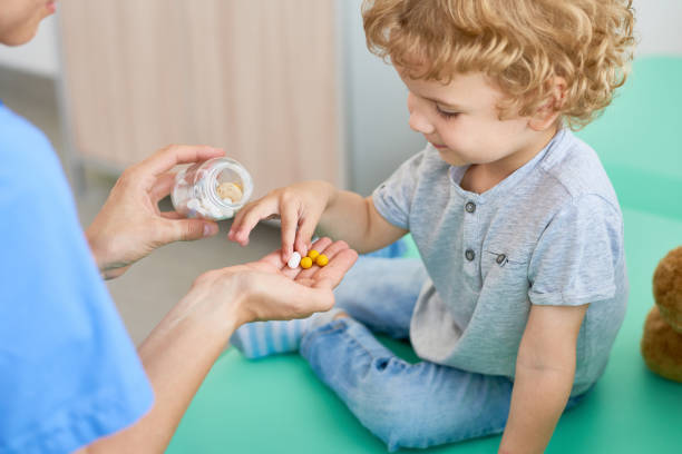 istock Giving Vitamins to Curly Little Patient 849176586